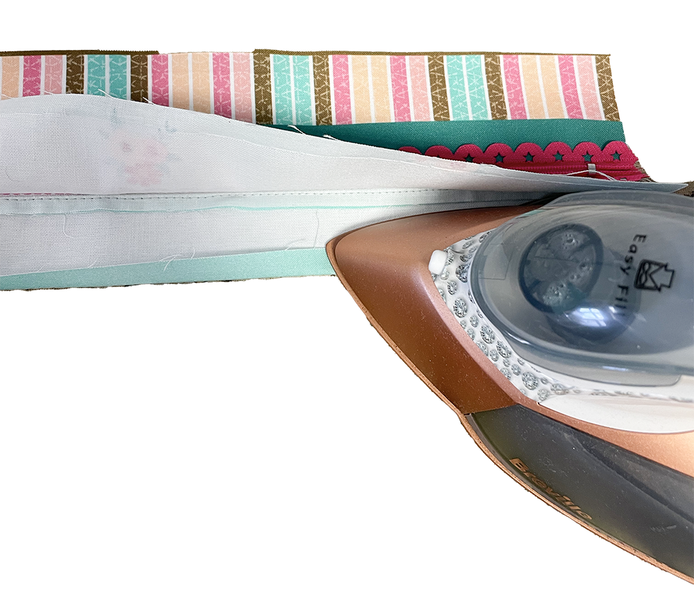 Press up 1cm seam allowance on the lower zipper lining piece